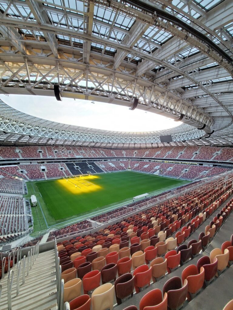 Explore the vastness of this modern football stadium with panoramic seating and open roof.